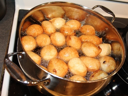 Beignet frying to a golden finish